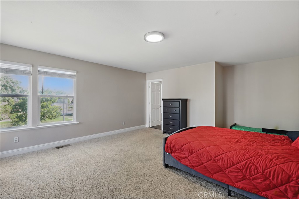 1235 Sunrise Drive Merced, CA 95348 - Photo 22 of 44 a bed sitting in a spacious bedroom next to a window