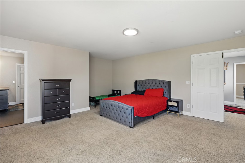 1235 Sunrise Drive Merced, CA 95348 - Photo 23 of 44 a spacious bedroom with a bed and a desk