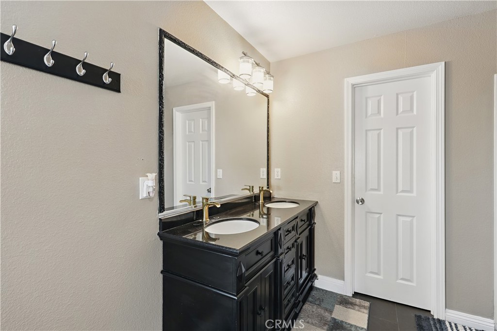 1235 Sunrise Drive Merced, CA 95348 - Photo 26 of 44 a bathroom with a sink vanity and a mirror