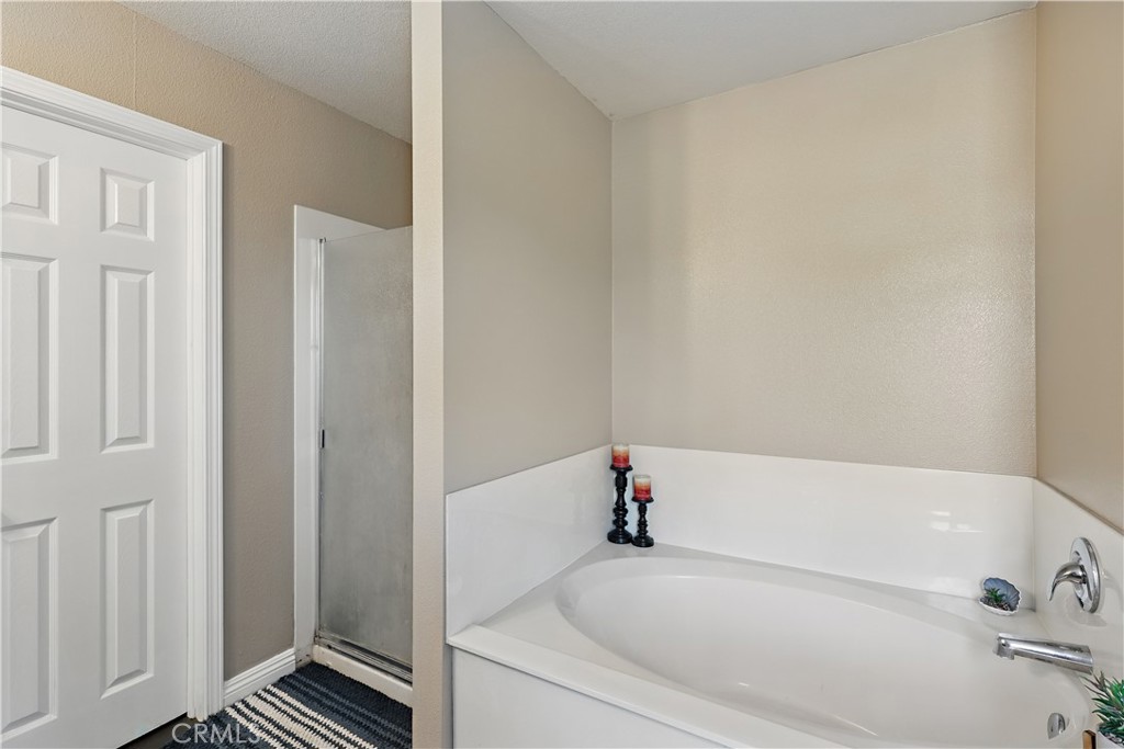 1235 Sunrise Drive Merced, CA 95348 - Photo 27 of 44 a white bath tub sitting next to a shower