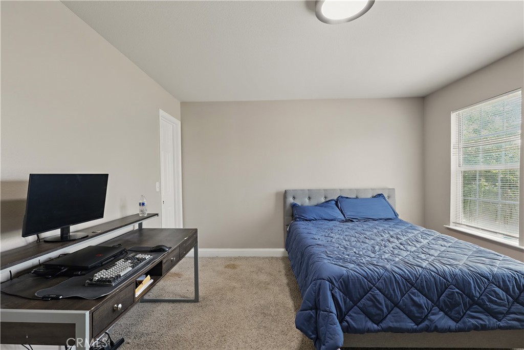 1235 Sunrise Drive Merced, CA 95348 - Photo 33 of 44 a bedroom with a bed and a flat screen tv