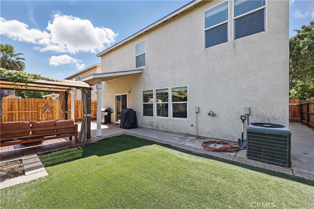 1235 Sunrise Drive Merced, CA 95348 - Photo 40 of 44 a view of a backyard with table and chairs and potted plants