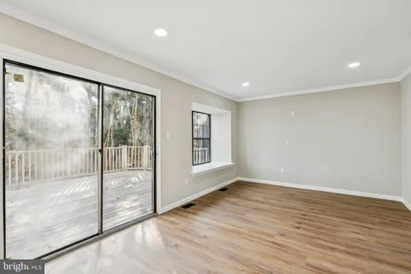 a view of an empty room with glass door