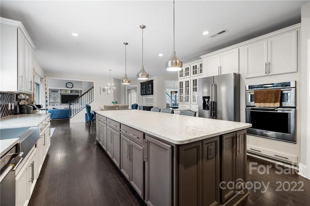 3000 Flowering Peach Road Marvin, NC 28173 - Photo 19 of 48 a kitchen with stainless steel appliances kitchen island a large island in the center