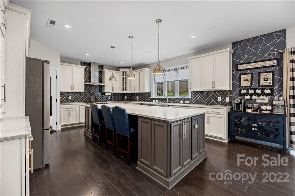 3000 Flowering Peach Road Marvin, NC 28173 - Photo 21 of 48 a kitchen with stainless steel appliances granite countertop a sink a stove and a refrigerator