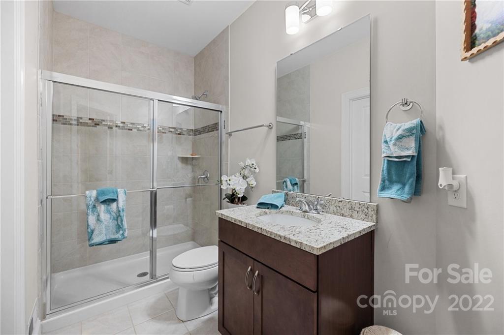 3000 Flowering Peach Road Marvin, NC 28173 - Photo 29 of 48 a bathroom with a granite countertop sink toilet and shower