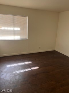 1440 East Vegas Valley Drive, Unit 7 Las Vegas, NV 89169 - Photo 19 of 19 Unfurnished room featuring baseboards and dark wood-style floors