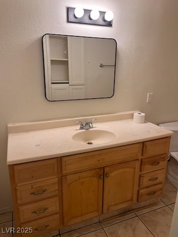 1440 East Vegas Valley Drive, Unit 7 Las Vegas, NV 89169 - Photo 3 of 19 Half bath with vanity, light tile patterned floors, and a textured wall