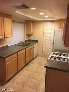 1440 East Vegas Valley Drive, Unit 7 Las Vegas, NV 89169 - Photo 4 of 19 Kitchen with dark countertops, light tile patterned floors, recessed lighting, and white appliances