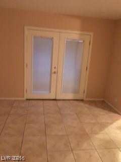 1440 East Vegas Valley Drive, Unit 7 Las Vegas, NV 89169 - Photo 6 of 19 Spare room with french doors and light tile patterned floors