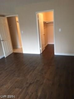 1440 East Vegas Valley Drive, Unit 7 Las Vegas, NV 89169 - Photo 9 of 19 Unfurnished bedroom with a spacious closet and dark wood-style flooring