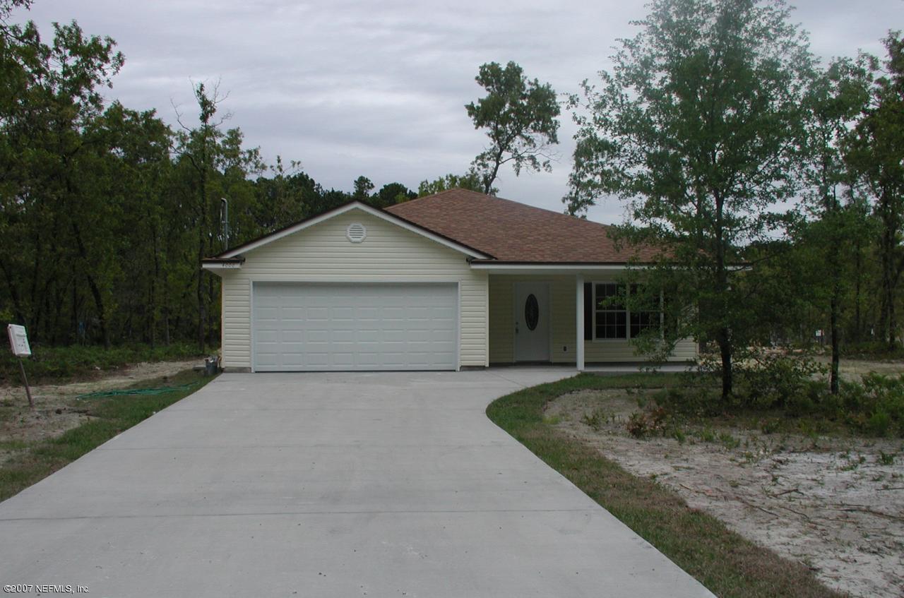 4000 Bronco Road Middleburg, FL 32068 - Photo 1 of 13 a front view of a house with a yard and garage