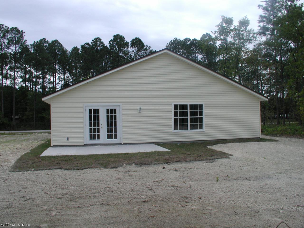 4000 Bronco Road Middleburg, FL 32068 - Photo 13 of 13 a view of a house with a yard and garage
