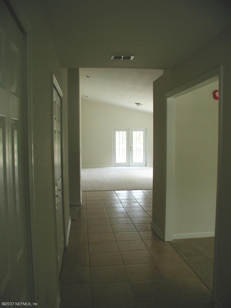 4000 Bronco Road Middleburg, FL 32068 - Photo 3 of 13 a view of hallway with windows and chandelier