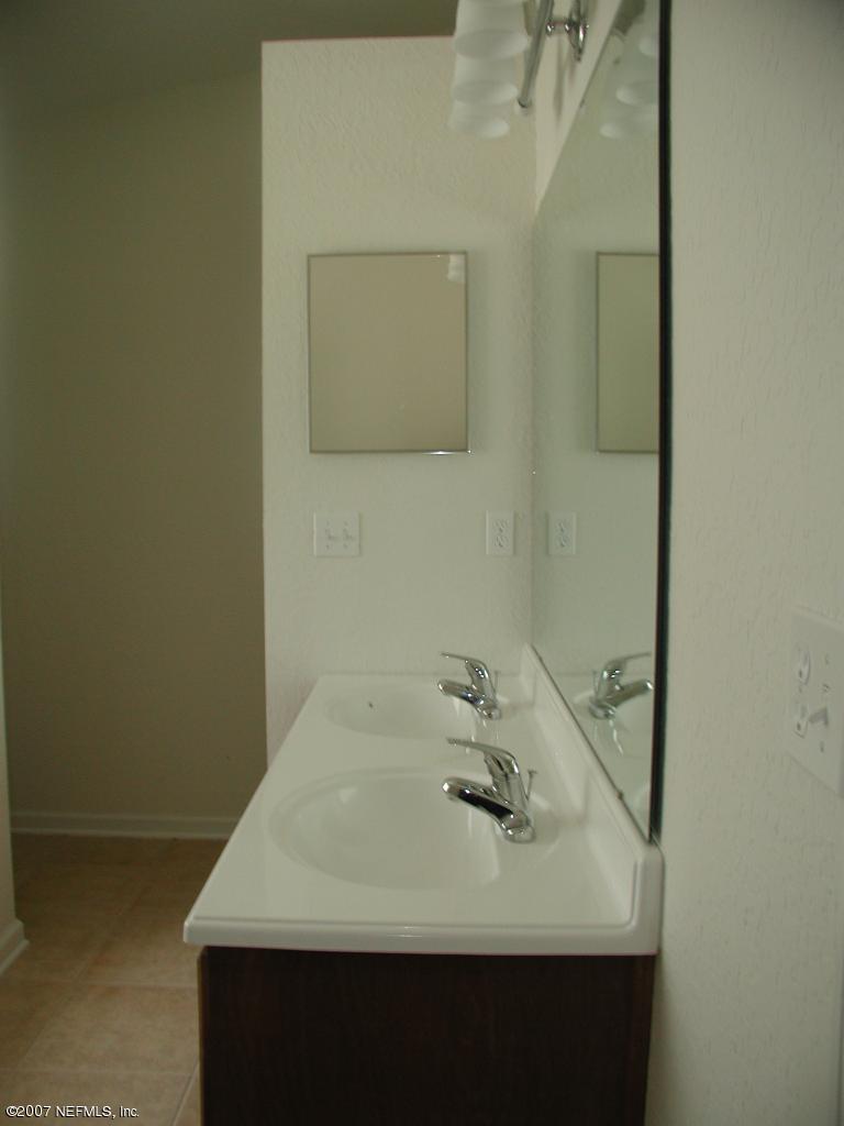 4000 Bronco Road Middleburg, FL 32068 - Photo 8 of 13 a bathroom with a sink and a mirror