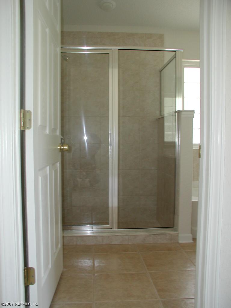 4000 Bronco Road Middleburg, FL 32068 - Photo 10 of 13 a bathroom with a glass shower door