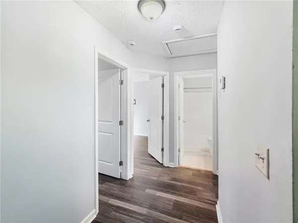a view of a room with wooden floor