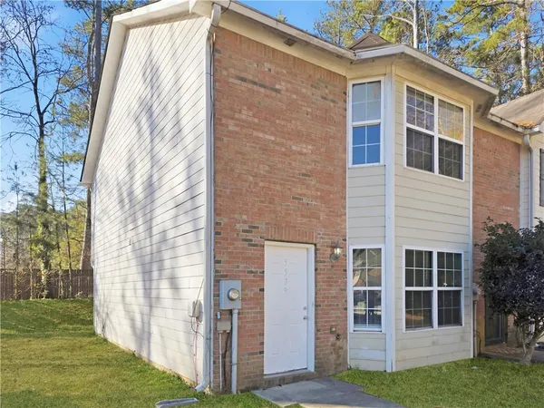 a view of a house with brick walls