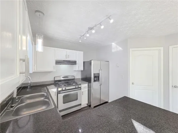 a kitchen with a stove and a refrigerator