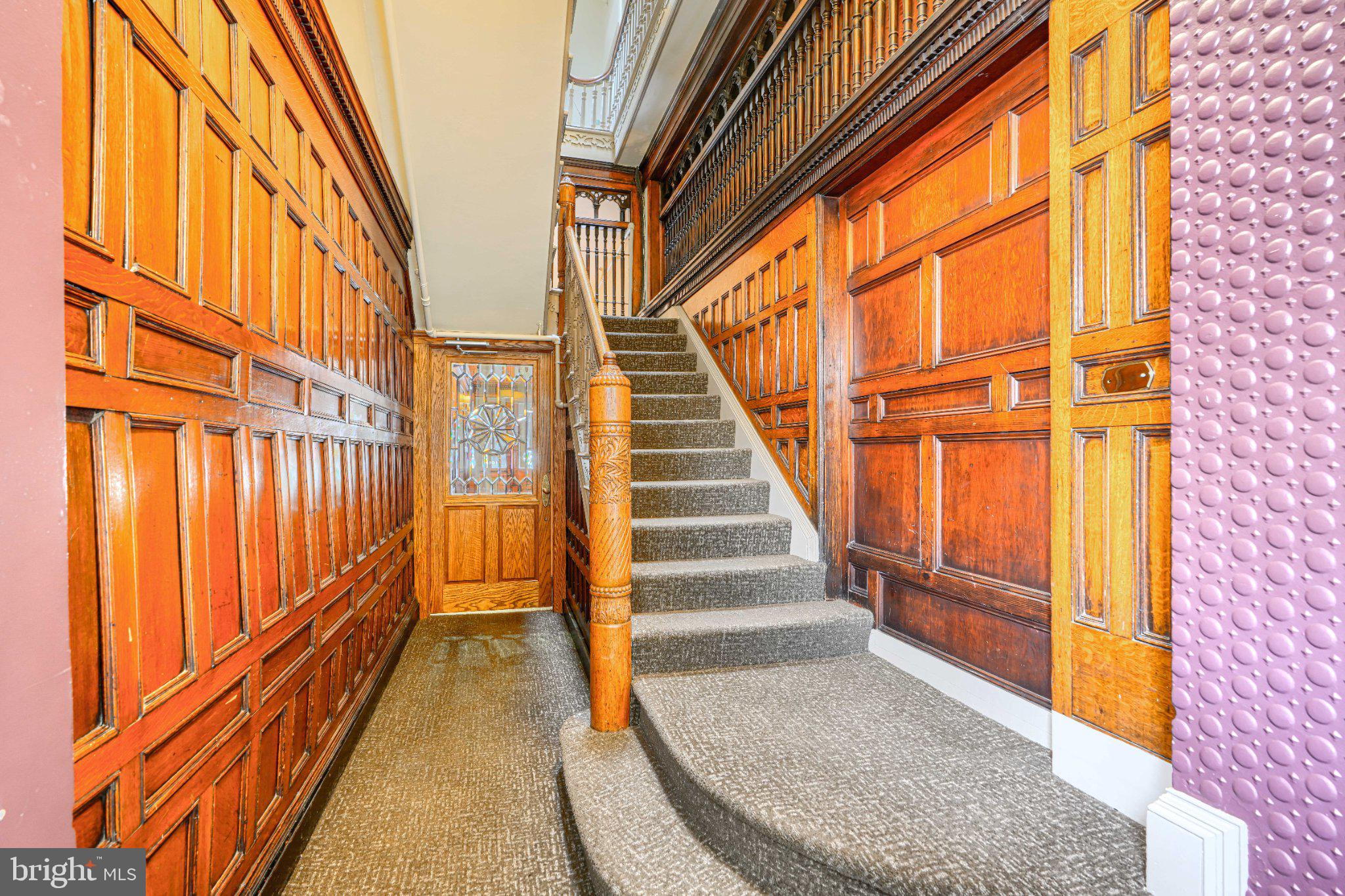 1018 North Charles Street, Unit R Baltimore, MD 21201 - Photo 2 of 17 Elegant staircase with rich wood paneling.