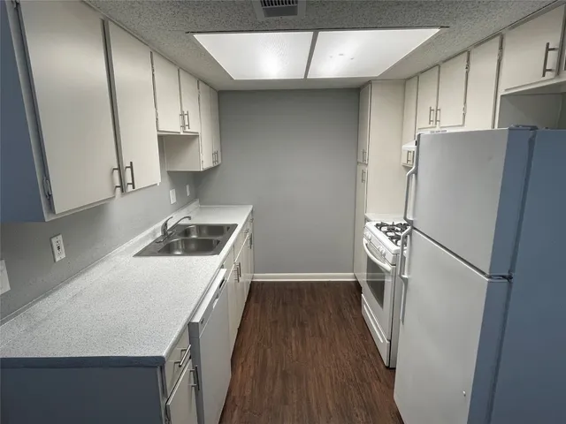 a kitchen with a refrigerator sink and stove