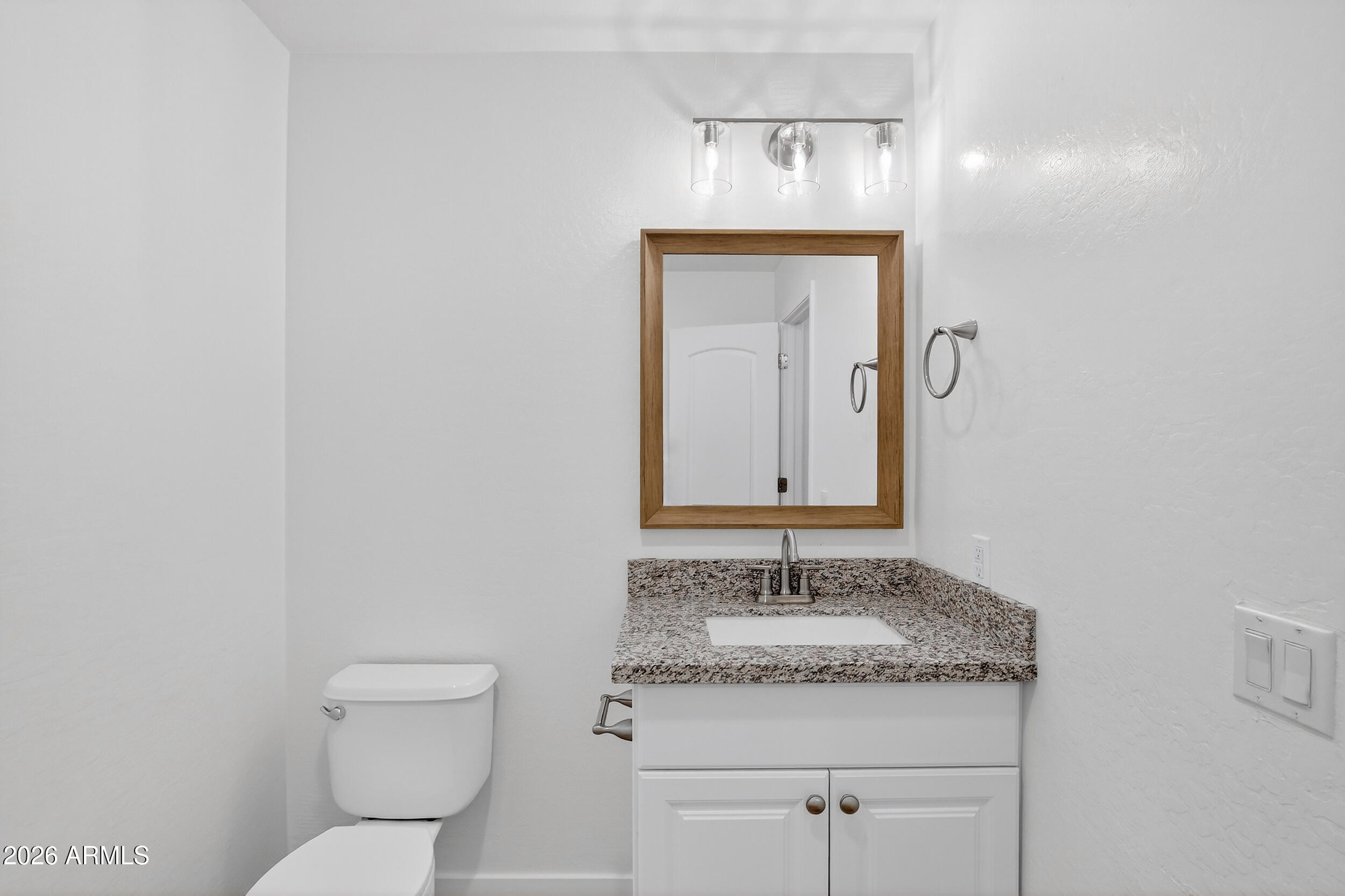 43620 West Cowpath Road Maricopa, AZ 85138 - Photo 8 of 60 a bathroom with a granite countertop sink and a toilet
