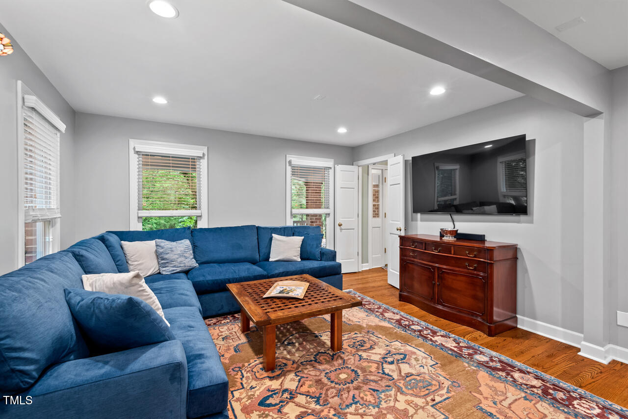 9900 2 Robins Court Raleigh, NC 27613 - Photo 15 of 83 a living room with furniture and a flat screen tv