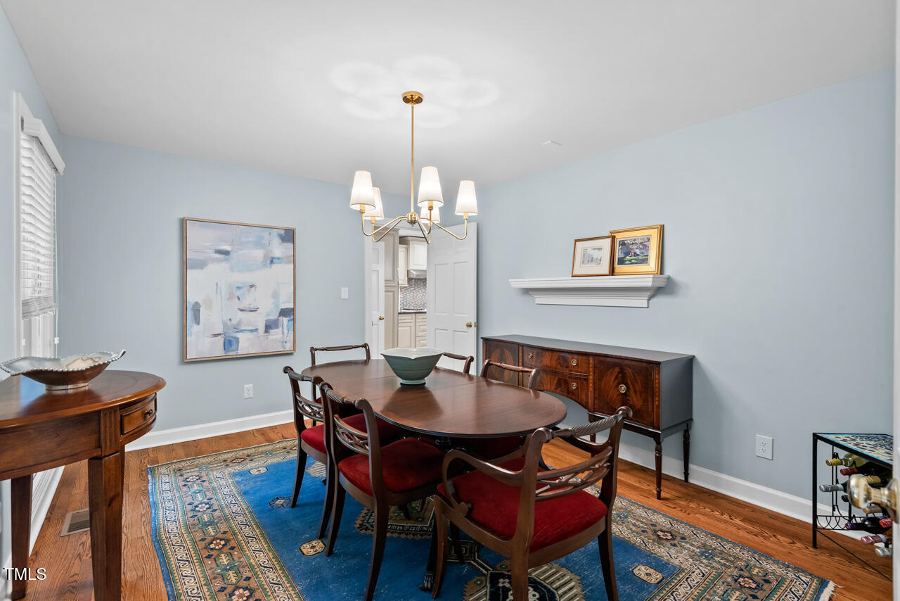 9900 2 Robins Court Raleigh, NC 27613 - Photo 17 of 83 a view of a dining room with furniture window and wooden floor