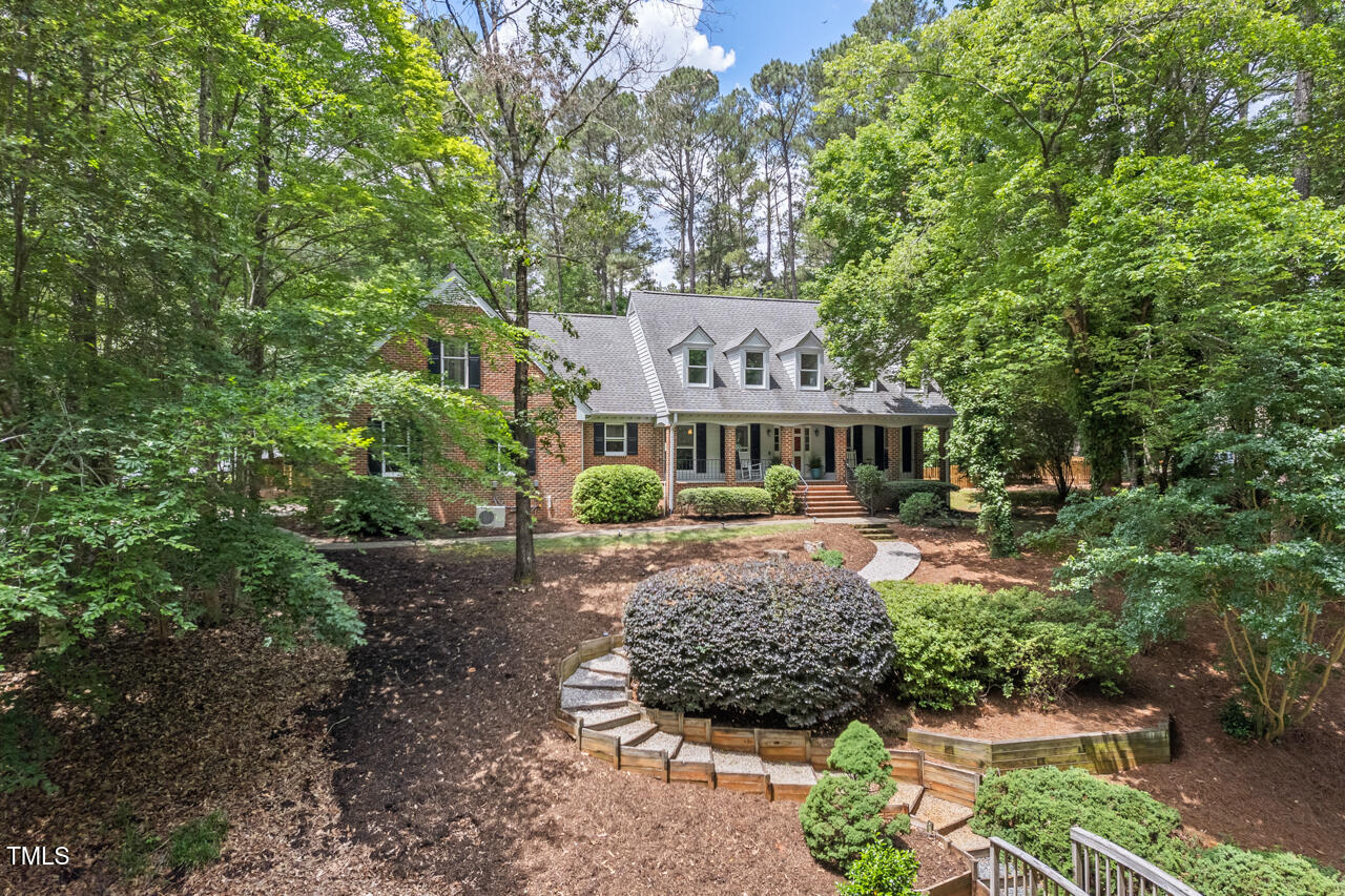 9900 2 Robins Court Raleigh, NC 27613 - Photo 2 of 83 a front view of a house with a garden
