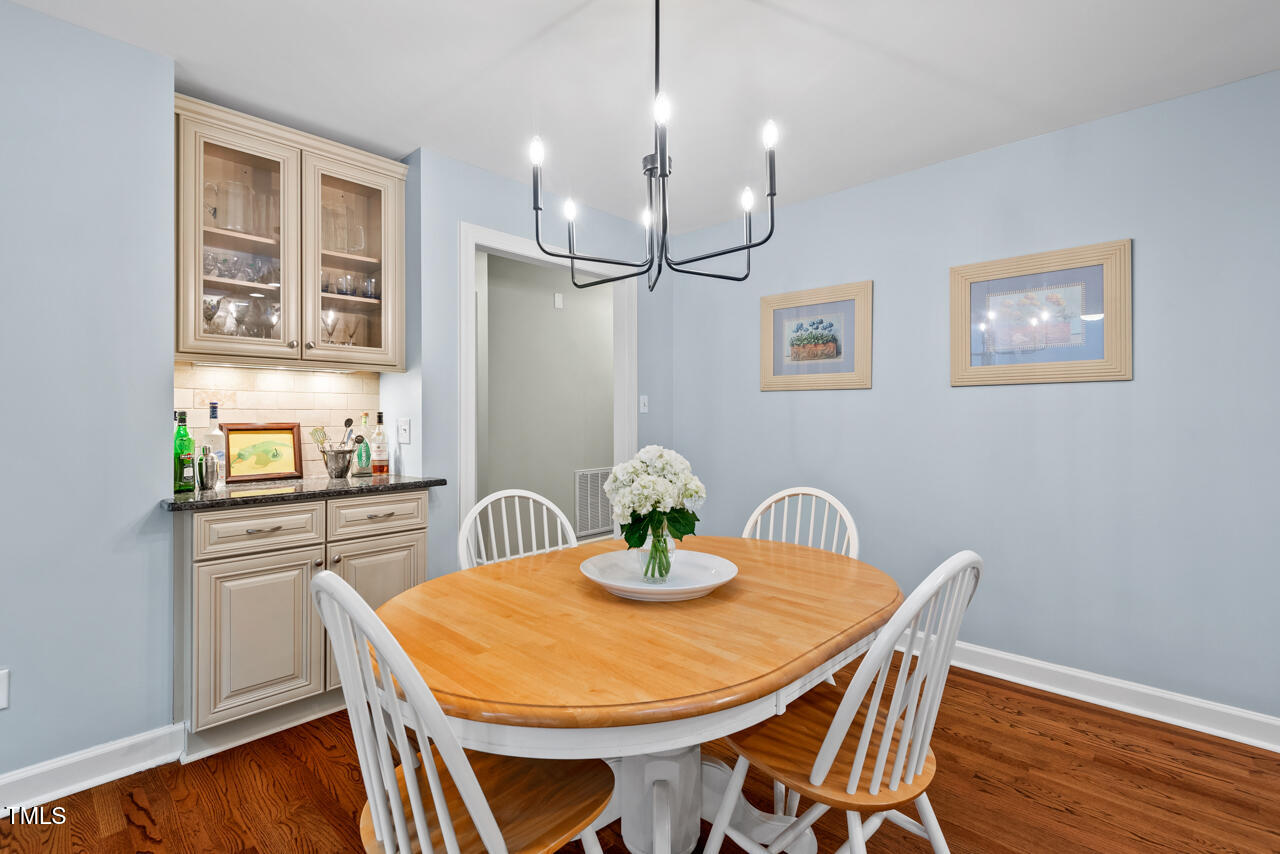 9900 2 Robins Court Raleigh, NC 27613 - Photo 27 of 83 a kitchen with stainless steel appliances kitchen island a table and chairs in it