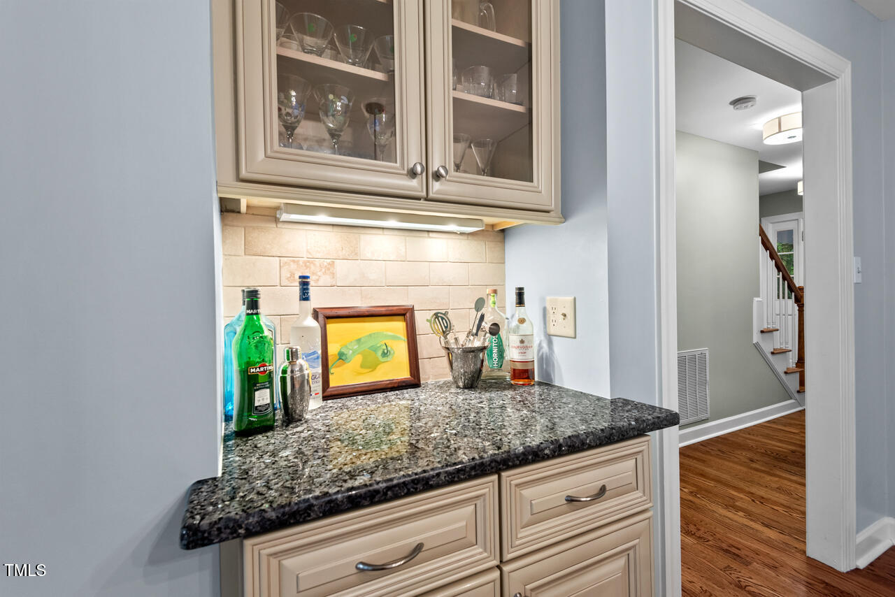 9900 2 Robins Court Raleigh, NC 27613 - Photo 28 of 83 a kitchen with granite countertop a sink and cabinets
