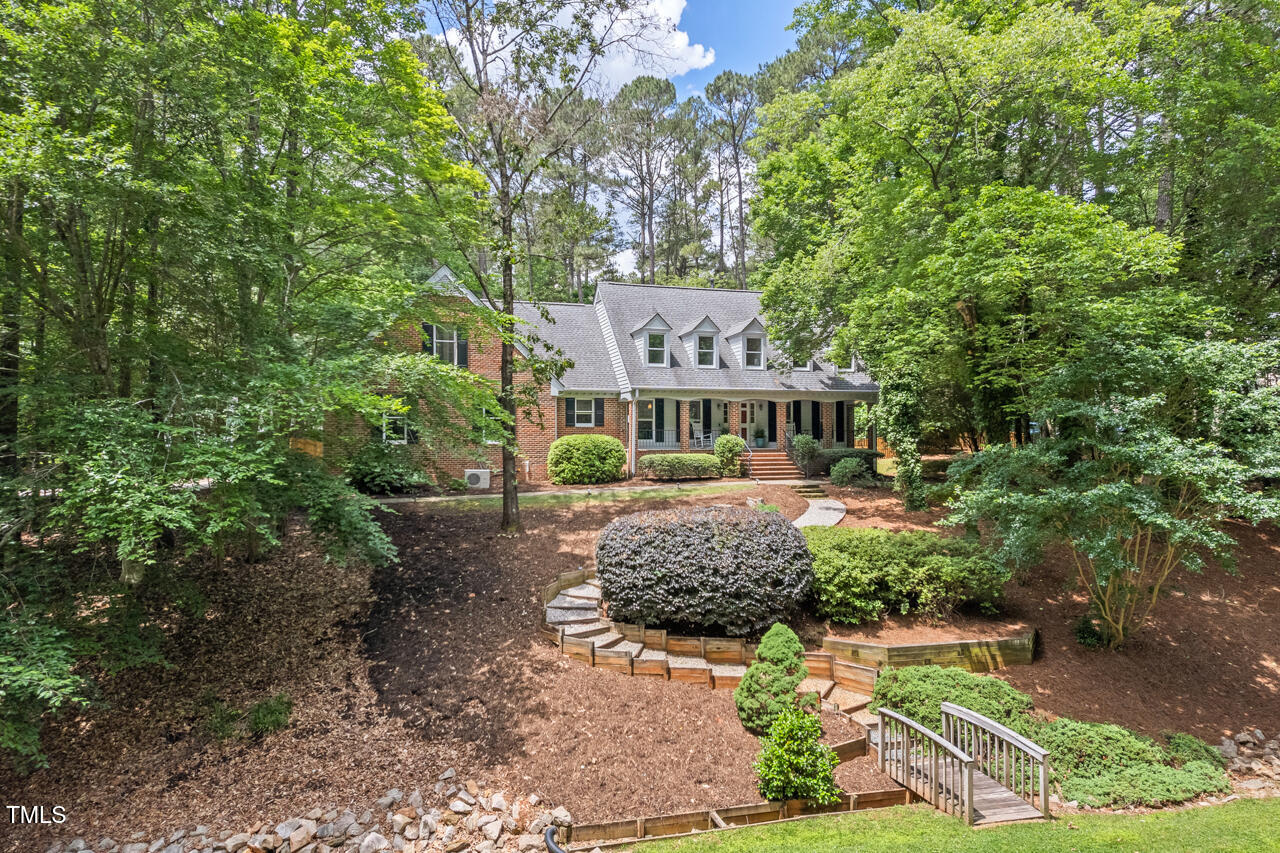 9900 2 Robins Court Raleigh, NC 27613 - Photo 3 of 83 a front view of a house with a yard