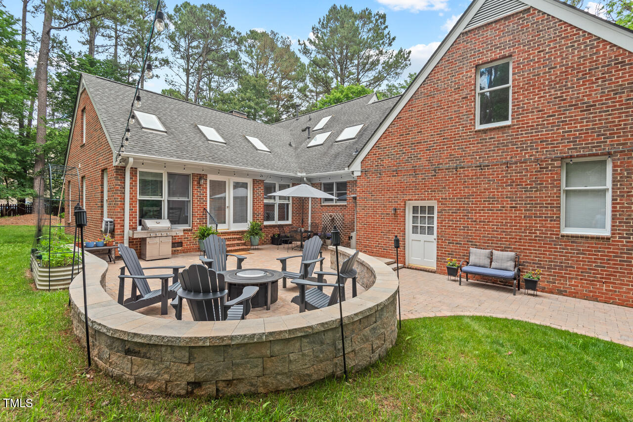 9900 2 Robins Court Raleigh, NC 27613 - Photo 34 of 83 a view of a house with backyard sitting area and garden