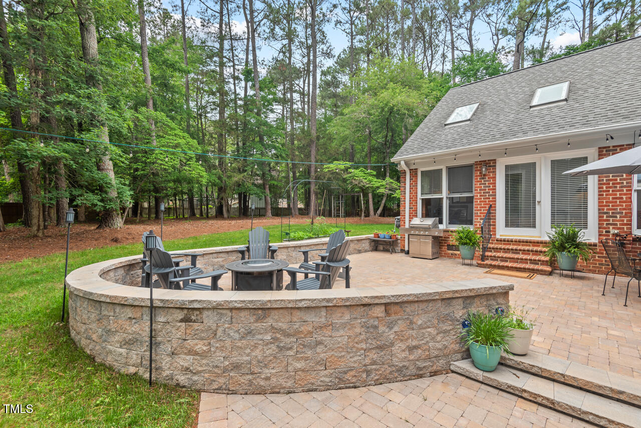 9900 2 Robins Court Raleigh, NC 27613 - Photo 35 of 83 a view of a house with backyard sitting area and swimming pool