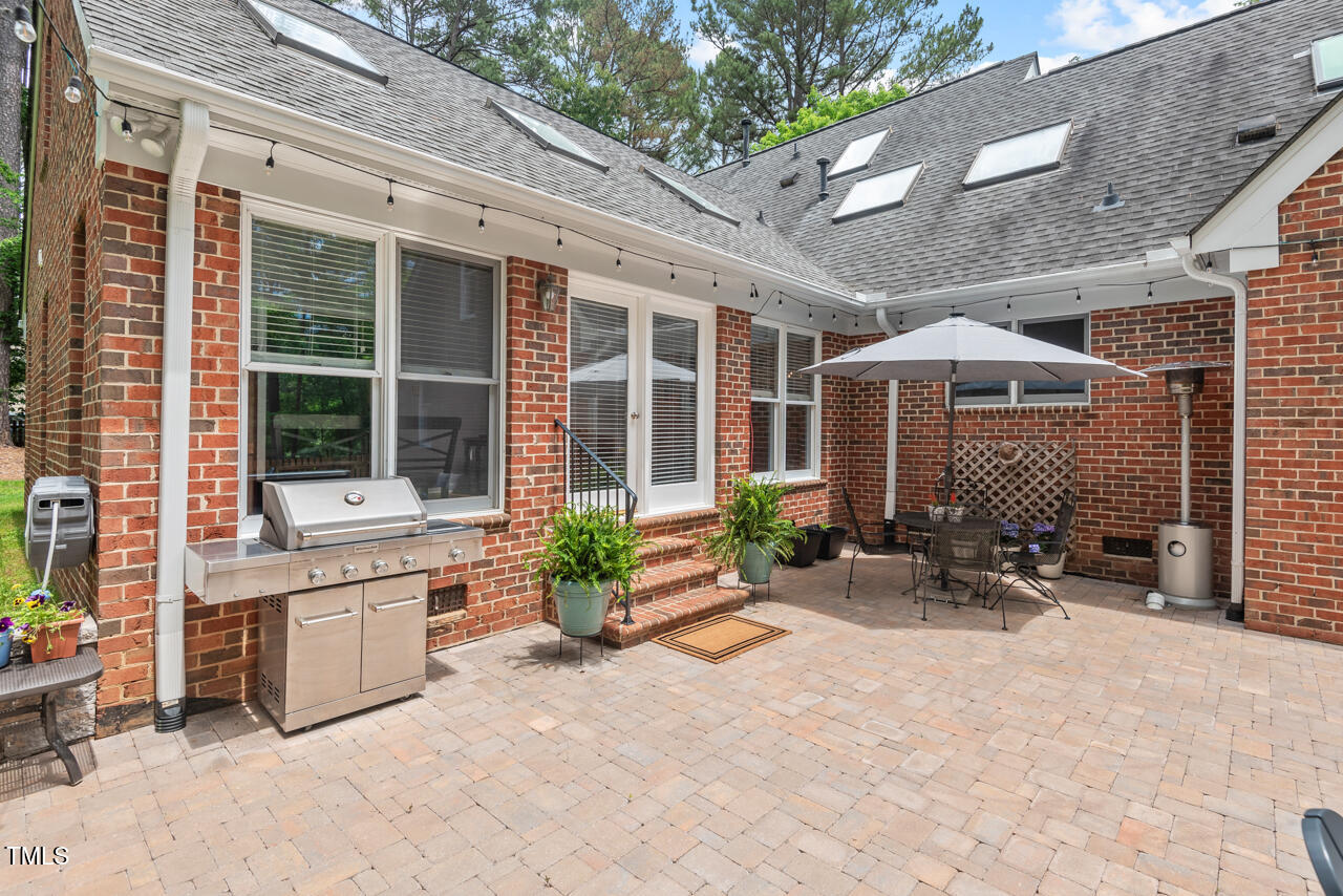 9900 2 Robins Court Raleigh, NC 27613 - Photo 36 of 83 a row of table and chairs in front of house
