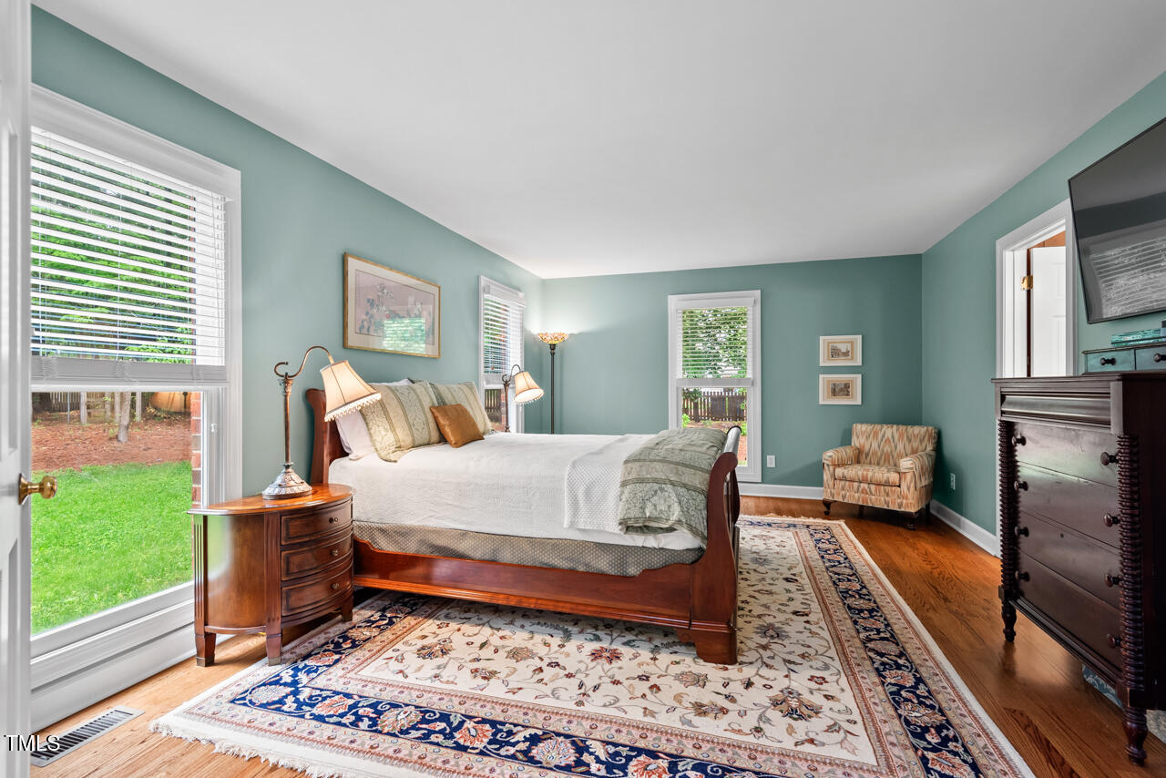 9900 2 Robins Court Raleigh, NC 27613 - Photo 38 of 83 a bedroom with a bed and wooden floor