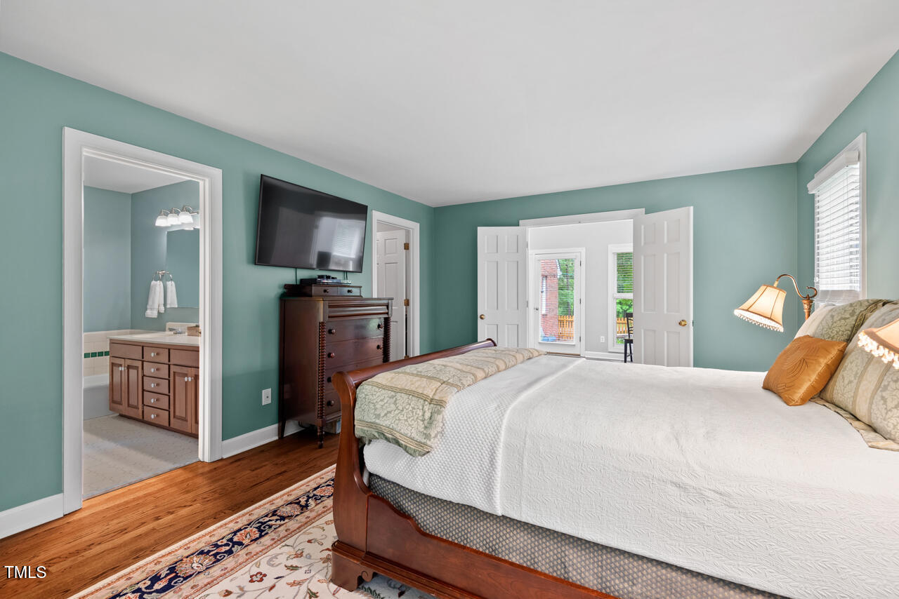 9900 2 Robins Court Raleigh, NC 27613 - Photo 40 of 83 a bedroom with a bed and wooden floor