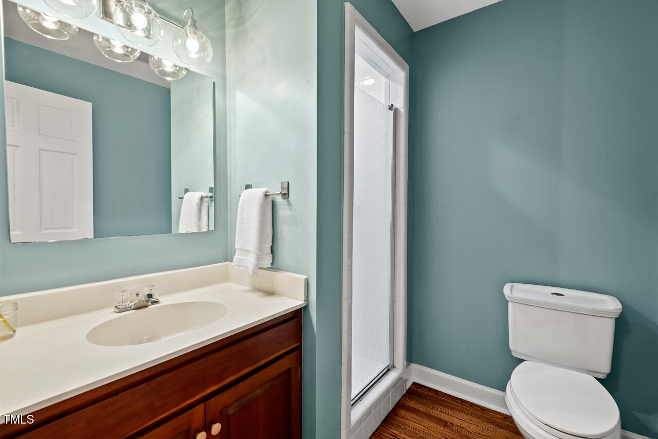 9900 2 Robins Court Raleigh, NC 27613 - Photo 45 of 83 a bathroom with a toilet sink and mirror