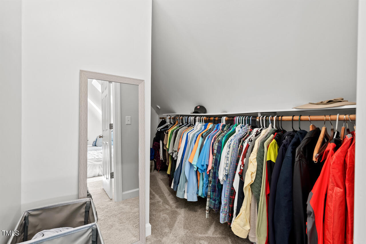 9900 2 Robins Court Raleigh, NC 27613 - Photo 53 of 83 a view of walk in closet with clothes and shoes