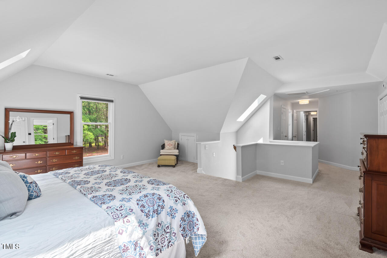 9900 2 Robins Court Raleigh, NC 27613 - Photo 54 of 83 a bedroom with a bed and a couch