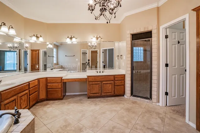 a large bathroom with a large tub sink and mirror