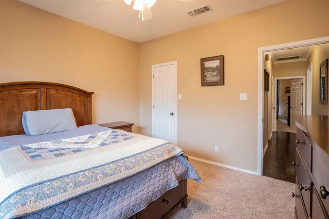 a bedroom with a bed and a lamp