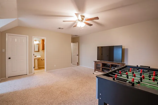 a bedroom with bed and flat screen tv
