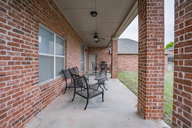 a view of a patio with a table and chairs