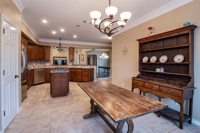 a kitchen with stainless steel appliances granite countertop a stove refrigerator and cabinets