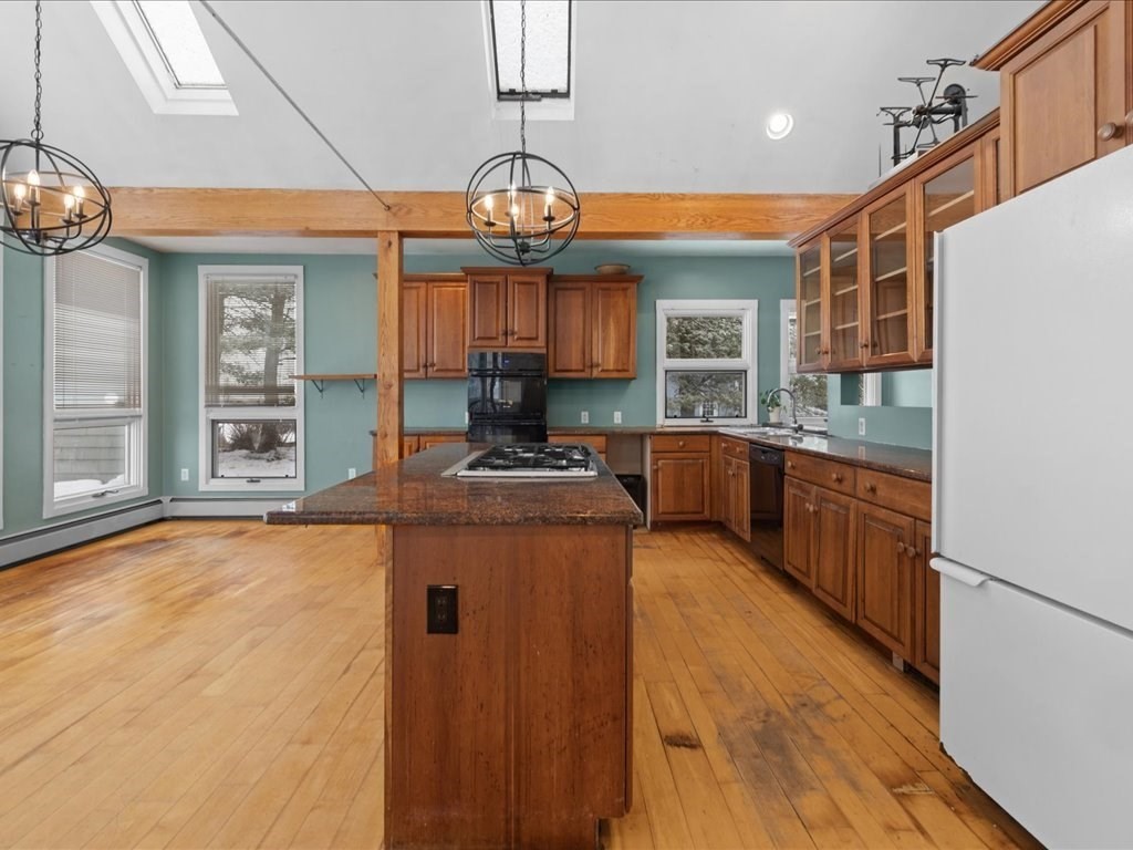 207 Pleasant Street Milton, MA 02186 - Photo 11 of 28 a kitchen with stainless steel appliances granite countertop a sink and cabinets