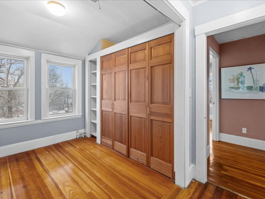 207 Pleasant Street Milton, MA 02186 - Photo 15 of 28 a view of empty room with wooden floor and fan
