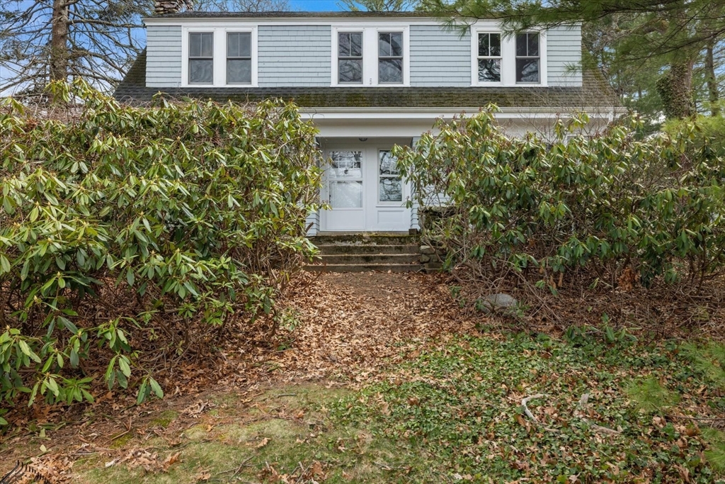 207 Pleasant Street Milton, MA 02186 - Photo 20 of 28 a front view of a house with a yard and garage