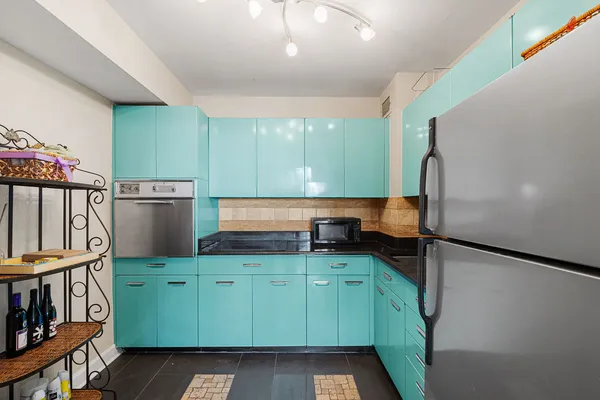 a kitchen with lots of counter space and a refrigerator