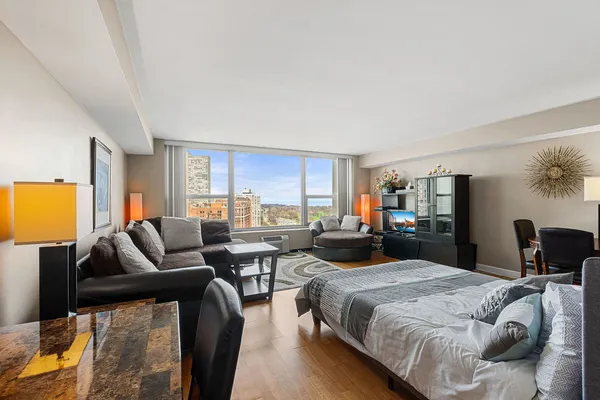 a bedroom with furniture and a large window